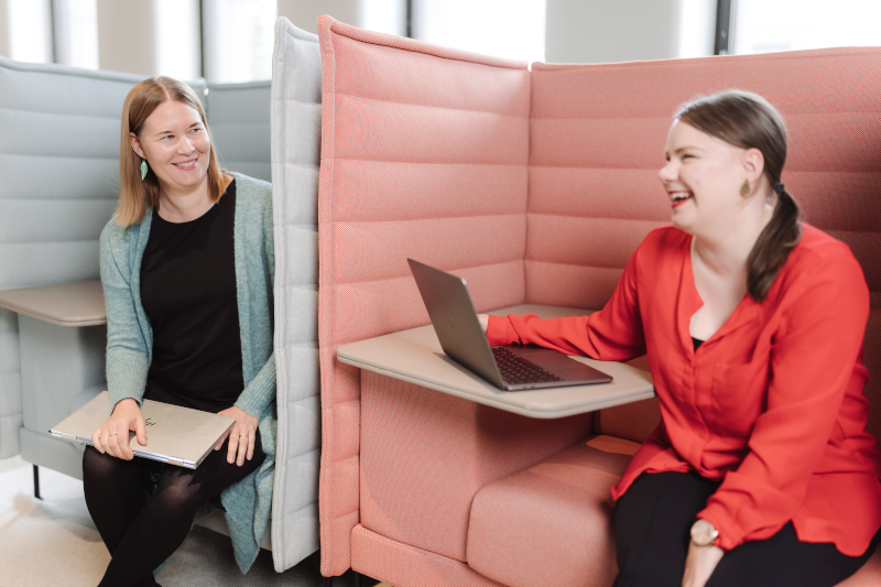 Laura Kultaranta ja Mira oiva hymyilevät toimistopöytien äärellä.